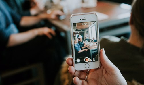 Someone making a video on their phone - Photo by Hermes Rivera on Unsplash